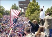 Democratic vice presidential candidate John Edwards (in white
shirt) addresses a crowd outside Abe & Jake's Landing in
Lawrence. The Kerry-Edwards campaign train passed through Lawrence
without a stop early Saturday, where more than 1,000 people had
gathered. Edwards and his wife, Elizabeth (in black jacket), flew
back to Kansas on Sunday to make amends to those people who turned
out Friday in Lawrence.