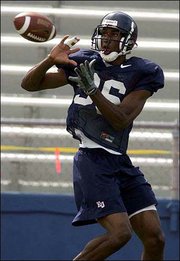 Kansas University wide receiver Marcus Henry prepares to make a
catch. Henry and the Jayhawks practiced Friday at Memorial Stadium.