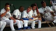 Lawrence High baseball product Kevin Hooper, second from left,
talks to Omaha Royals teammate Adrian Brown while sitting with Alex
Gomez and pitching coach Dave La Roche, right. Hooper hopes a
successful stint with the Omaha team leads to a promotion in the
future and a chance to play for the Kansas City Royals.