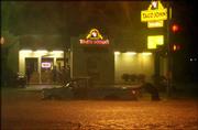 Lawrence police along with volunteers help push a truck out of the
intersection at 23rd and Ousdahl streets around 9:45 p.m. as the
water flooded a two-block area.
