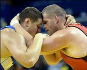 U.S. Greco-Roman wrestler Rulon Gardner, right, wrestles Lithuanian
Mindaugas Mizgaitis in a 66-kilogram bout. Gardner won three
matches Tuesday in Athens, Greece.