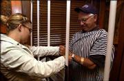 Anna Werner, an intern with March of Dimes, left, escorts Danny
Lucas, Lawrence, to "jail." Lucas, of Rock Chalk Car Wash,
participated in the Jail and Bail fund-raiser on Aug. 19 at the
Hereford House, Lawrence. He raised "bail money," which benefited
the March of Dimes, an agency that helps improve the health of
babies by preventing birth defects and infant mortality.
