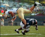 Kansas University's Tony Stubbs (9) sends Tulsa's Garrett Mills
head over heels in the first quarter of the Jayhawks' 21-3 victory.
KU held the Golden Hurricane to 141 total yards in the game
Saturday at Memorial Stadium.