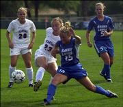 Kansas University's Nicole Braman tries to get the ball away from
Saint Louis University's Kara Kornfeld while teammates Emily
Strinden (20) and Kelly Ferguson (5) await the outcome. The
Jayhawks won the KUStore.com Tournament championship game, 2-0,
Sunday at Jayhawk Soccer Complex.