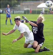 Kansas forward Caroline Smith, left, attempts to head the ball past
St. Louis University goalkeeper Lyndsay Gensler during the second
half. The Jayhawks beat the Billikens, 2-0, Sunday at the Jayhawk
Soccer Complex.