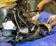 The remains of the Genesis capsule is examined in Dugway Proving
Ground, Utah. The space capsule, containing particles of solar
wind, was supposed have been snatched from the sky Wednesday by a
helicopter before hitting the ground. But the parachutes failed to
deploy.