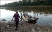 Kansas Department of Health and Environment and Department of
Wildlife and Parks employees prepare to launch from the North
Lawrence boat ramp to gather samples of carp and channel catfish on
the Kansas River just east of the Bowersock Dam. The fish will be
analyzed for toxic substances, to determine whether a consumption
advisory should remain in effect. At the front of the boat are
shock wires that will allow the researchers to collect samples by
net.