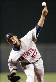 Minnesota twins starter Johan Santana fires a pitch to Baltimore's
Miguel Tejada. Santana blanked the Orioles, 9-0, for his 10th
straight victory Wednesday in Baltimore.