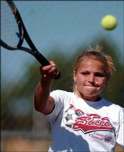 Lawrence High's Marti McDonald hits a return against Shawnee
Mission South. McDonald lost her match Wednesday at Lawrence High.