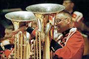 Tuba players perform with "The President&squot;s Own" U.S. Marine Band.
Two former Kansas University students play in the band, but will
remain in Washington when the band travels Wednesday to Lawrence.