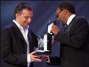 Spanish movie director Alejandro Amenabar, left, receives the
Silver Lion trophy from jury member Spike Lee. Amenabar won the
honor Saturday for his movie "Mar Adentro" or "The Sea Within."
