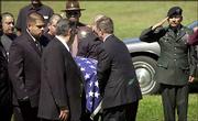 Jose Perez, the father of U.S. Army Pfc. Luis Perez, salutes as his
son's body is carried to his grave in Gary, Ind. Perez, who was
buried Friday, was killed Aug. 26, when the truck he was driving
struck a land mine in Iraq.