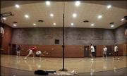 Norman Krause, in dark shirt, and other players share a friendly
game of competitive badminton at the First Presbyterian Church in
Hutchinson. Krause has been playing badminton since after
completing his service in the Navy in World War II.