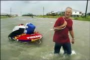 After gathering as much as he could from his Dauphin Island, Ala.,
home, Jeff Deen, 52, wades through the island&squot;s already-flooded
streets on his way to Mobile, Ala. "If it&squot;s this bad already, I
hate to see what is going to happen later," Deen said Wednesday
afternoon. "I may be the last one here. The police are even gone."