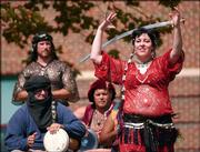 Jemira Ali, Lawrence, balances a sword on her head during a
performance at South Park during the sesquicentennial celebration.
Ali is a member of the Moroccan Marauders, a Lawrence-based
belly-dancing group specializing in Arabic and Flamenco dancing.