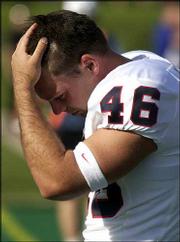 KU kicker Johnny Beck hangs his head after missing what would have
been the game-tying field goal against Northwestern.