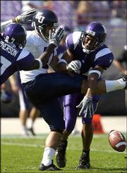 Kansas University punter Chris Tyrrell gets swarmed by Northwestern
defenders trying to punt the ball after a fumbled snap.
Kicking-game woes -- Tyrrell's fumble and two missed field goals --
contributed to KU's 20-17 loss to Northwestern on Saturday in
Evanston, Ill.