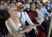 Foreground at left, Judy and Jerry Niebaum, Lawrence, sing along
with other attendees at the closing ceremony of the Lawrence
Sesquicentennial at Sesquicentennial Point at Clinton Lake. A large
time capsule was buried during the event Sunday.