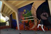 Lawrence artist Dave Loewenstein prepares to paint a large
sectional mural on the walls at Municipal Stadium, 11th and
Delaware streets. Loewenstein worked Friday on the mural, which he
said was a collaborative design featuring concepts from Lawrence's
150 years.