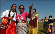 Native dancers, from left, Alayna Ahhaitty, Emma Spottedhorse, 10,
Cynthia Sowter, Angie Sandcrane, 7, and Erin Casoose, 7, chat
during the opening of the Haskell Indian Nations University 120th
birthday powwow. Haskell celebrated its birthday with song and
dance Sept. 18 at the university.