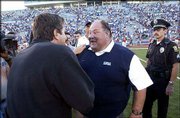 Kansas University coach Mark Mangino, right, congratulates Texas Tech coach Mike Leach at midfield after the Red Raiders defeated the Jayhawks in 2004.