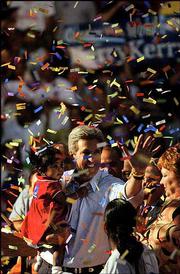 Democratic presidential nominee Sen. John Kerry, D-Mass., holds
Faith Sutton, 2, at the conclusion of a rally in Kissimmee, Fla.