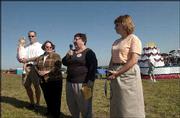 Clenece Hills, center, president of the Lawrence Sesquicentennial
Commission, introduces descendants of Amos Lawrence, for whom the
city is named, during a closing ceremony of the Lawrence
sesquicentennial celebration. From left are Charles Derby and his
21-month-old daughter Lillian, Lawrence, Elizabeth Hedenberg,
Pensacola, Fla., and her cousin Brenda Muntz, Olathe. The ceremony
was Sept. 19 at Sesquicentennial Point at Clinton Lake.