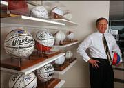 Crown Chevrolet owner Miles Schnaer supplies some of the cars to
the Kansas University Athletic Corp. Schnaer is pictured on Friday
with his collection of signed KU basketballs, footballs and
baseballs.