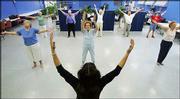 Tai Chi instructor Paula Abbott, foreground, gets her class going
with warm-up stretches as they take part in the exercise class at
the Donelson Senior Citizens Center in Nashville, Tenn. Exercise
programs once considered exotic, such as tai chi and yoga, have
become as routine at senior centers as bridge and shuffleboard.