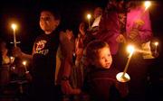 Jordan Peek, right, holds hands with his brother, Austin Peek,
during a Sunday candlelight vigil in memory of Jack Hensley at the
Tega Cay Beach Club, in Tega Cay, S.C. Hensley was held hostage and
killed in Iraq.