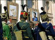 Tapestries of of nun Anna Katharina Emmerick and Karl I hang
outside St. Peter's Basilica at the Vatican above unidentified men
in Austro-Hungarian era uniforms during a Sunday beatification
ceremony held by Pope John Paul II.