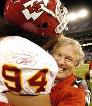 Chiefs coach Dick Vermeil, right, gets a hug from defensive tackle
Junior Siavii after the Chiefs edged the Ravens.