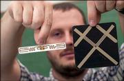 Dan Deavours, assistant research professor at Kansas University's
Information and Telecommunication Technology Center, displays
examples of radio frequency identification tags. The devices, which
are placed on merchandise, allow companies to keep better track of
their inventories. Deavours was pictured Tuesday at the center.