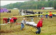 Emergency personnel remove a victim from the scene of a bus crash
in Marion, Ark. The driver of the tour bus and 15 passengers were
killed in the crash early Saturday. Police say the bus was carrying
31 Chicago tourists to a casino in Tunica, Miss., when it
overturned along Interstate 55.
