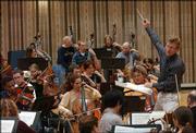 Kansas University Symphony Orchestra conductor Nicholas Uljanov
leads the orchestra during rehearsal last week at Murphy Hall. The
orchestra will celebrate its 100th anniversary with a gala concert
Tuesday at the Lied Center.