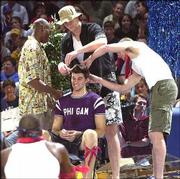 Jeff Carey had his hair clipped by Kenny Gregory, left, Eric
Chenowith, center, and Luke Axtell at the 2000 Late Night.
