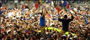 Kansas University fans haul the Memorial Stadium goalposts to
Potter Lake after the Jayhawks beat Kansas State. The KU victory
Saturday prompted a mass of students and fans to rush onto the
field, tearing down the goalposts and causing minor damage.