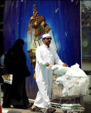 A Saudi family shops Monday in Jeddah, Saudi Arabia. Women can
neither run nor vote in Saudi Arabia's first nationwide municipal
elections next year, officials said Monday.