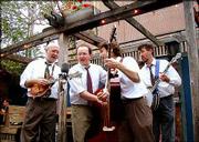 Kory Willis, left, Paul Schmidt, Mike Horan and Leo Posch formed
The Midday Ramblers in the late 1990s. On Sunday, the Lawrence
quartet, shown performing at The Replay Lounge, 946 Mass., will
celebrate the release of its third album, "Bluegrass Music is Fun!"