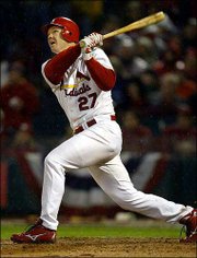 St. Louis slugger Scott Rolen follows through on the first of his
two home runs against Houston. Rolen helped the Cardinals edge
Houston, 6-4, in Game 2 of the National League championship series
on Thursday in St. Louis.