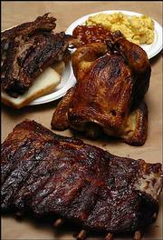 Lawrence residents no longer need to drive to Kansas City to find
barbecued fare such as these ribs and chicken. Lawrence has six
establishments that are ready to help satisfy cravings for smoked
meats.