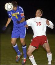 Lawrence High's Liam Kirby, right, fights for the ball with Olathe
South's Brett Childers. South won, 1-0, Tuesday at the Youth Sports
Inc fields.