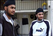 French Sikhs Bikramjit Singh and Jasvir Singh stand Wednesday at
the Sikh temple of Bobigny, France. The boys have been kept out of
class since the start of September, in accordance with the law
banning all conspicuous religious signs from public schools, which
went into effect at the start of the academic year on Sept. 2. In
the first court case resulting from the law, Sikh leaders have
asked a court to force the school to convene a disciplinary hearing
or let the boys into classrooms. A ruling is expected Friday.