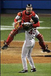 Boston catcher Jason Varitek leaps into the arms of pitcher Alan
Embree after the Red Sox beat the Yankees, 10-3.