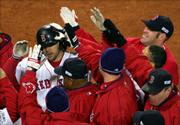 Boston's Mark Bellhorn is mobbed by teammates after his decisive
two-run home run. The eighth-inning blast gave the Red Sox an 11-9
victory Saturday night in Boston.