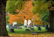 Tim Talbott and Wendy Burkett pause while touring the Olathe
Cemetery Tuesday. A number of Kansas cities offer tours of sites
that are rumored to be haunted, including cemeteries, hotels and
homes. So far, Lawrence does not have an organized tour, but Web
sites offer many ideas for places that could be included on such a
tour.