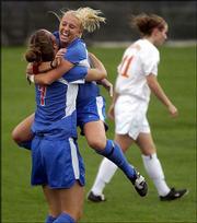 Kansas University's Rachel Gilfillan, left, is congratulated by
Afton Sauer after Gilfillan's goal. The Jayhawks defeated Iowa
State, 4-0, and won a share of the Big 12 Conference crown.