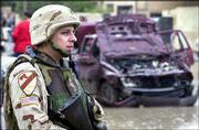 A U.S. Army soldier guards the site of a car bomb explosion near an
office of the Iraqi Ministry of Education in Baghdad, Iraq. The
bomb was one of two Tuesday, the other wounding civilians and seven
Iraqi soldiers in Mosul.