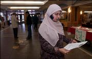 Asma Rehman, president of Muslim Student Assn. of Kansas
University, chats with a friend on the phone at the Kansas Union.
Rehman, a senior from Kansas City, Mo., is fasting during Ramadan.
She is recruiting participants for the organization's upcoming
Fast-A-Thon.
