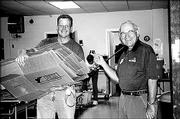 Intrust Bank employees Doug Gaumer, left, and Don Johnston
volunteer at the Salvation Army. They participated Sept. 24 in the
United Way of Douglas County's Fall Day of Caring.